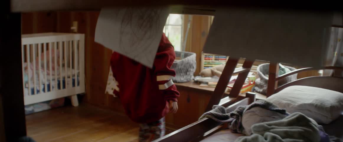 A young child climbs out of bed