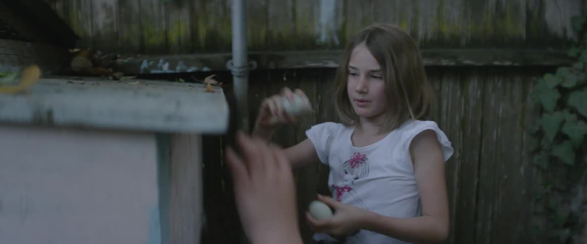 A young girl opens a wooden container