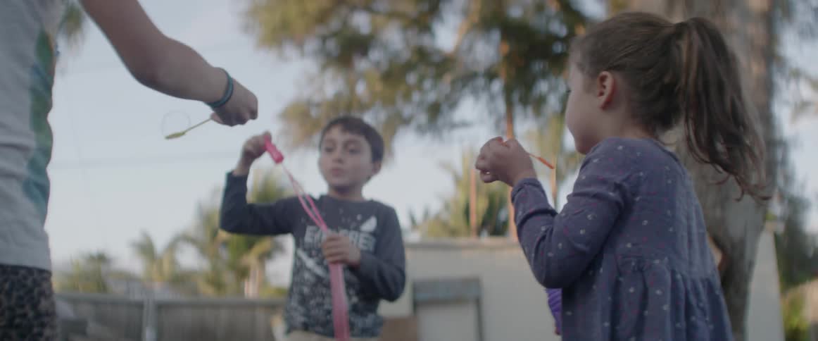 Children blow bubbles on a sunny day