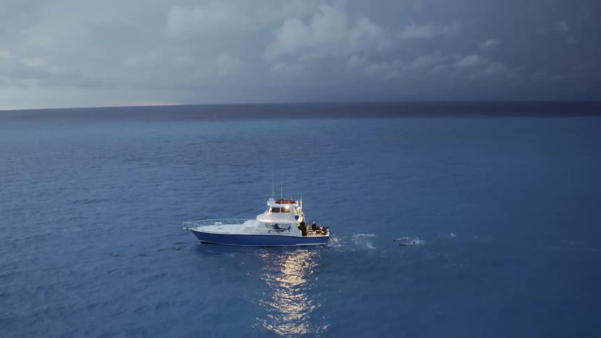 A ship sails on the ocean during a lightning storm