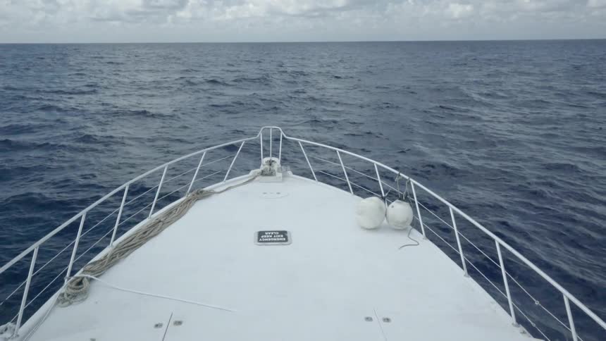 Boat travels over the water creating waves