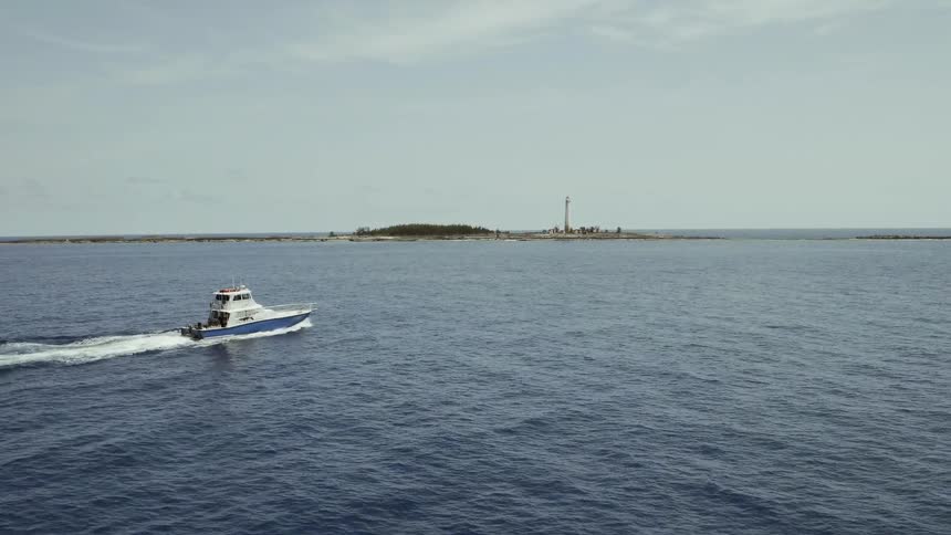 Boat travels over the water under a blue sky