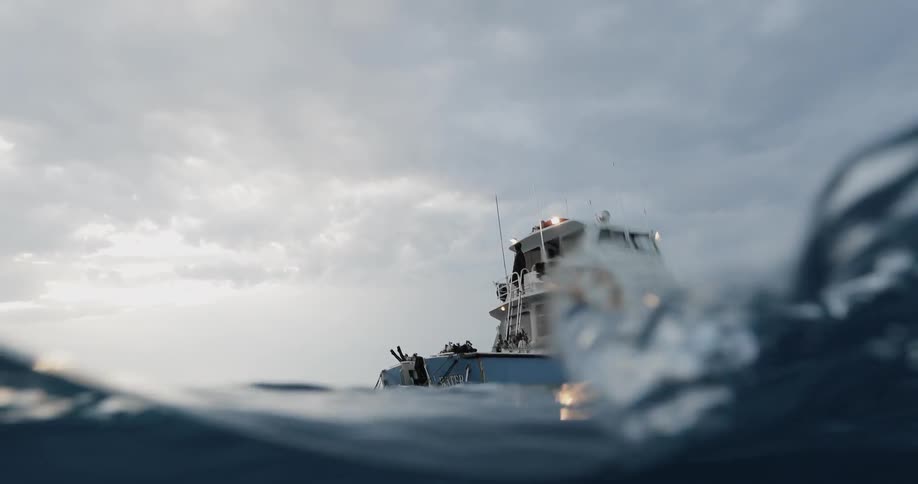 Boat floats on the surface of the rough water