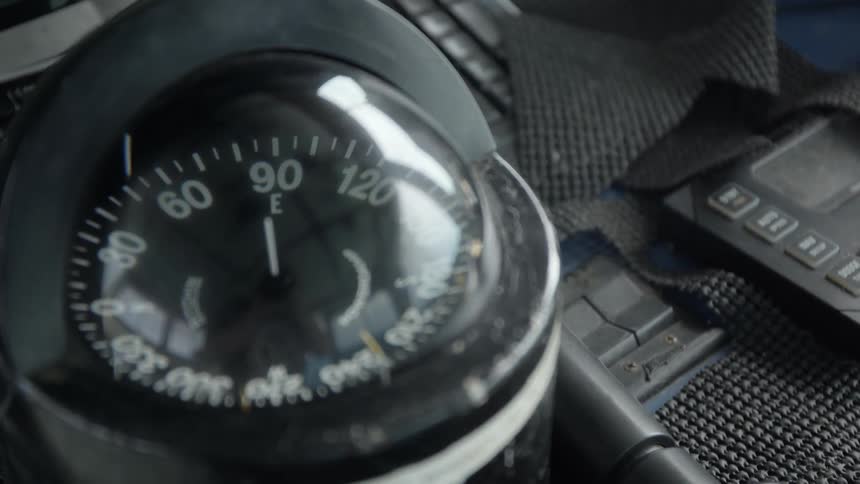 The compass inside a boat is pointing towards east