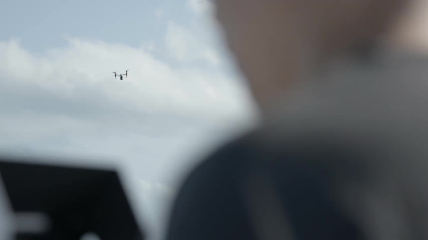 A young boy flies a drone