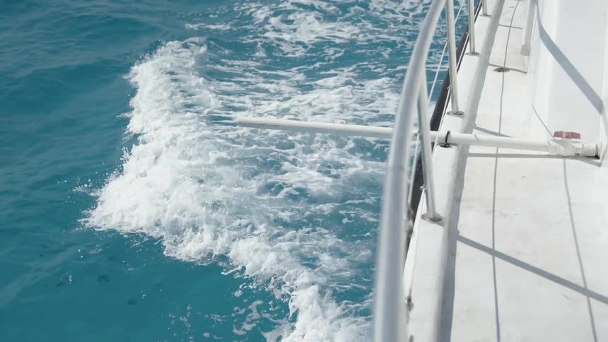 Boat creates waves as it travels through the water