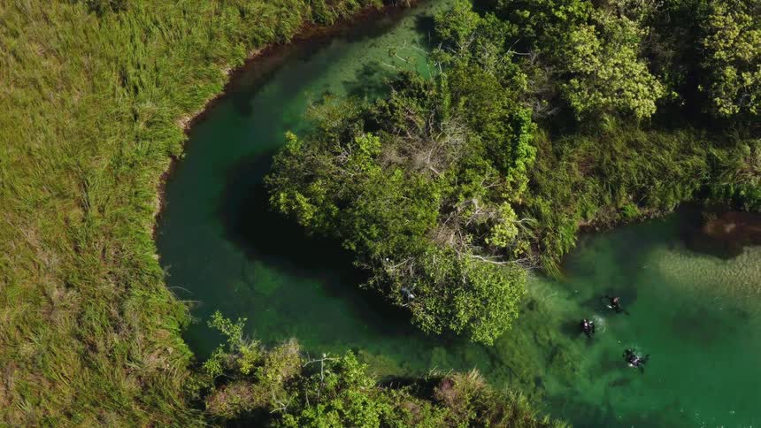 People are swimming in the spring below
