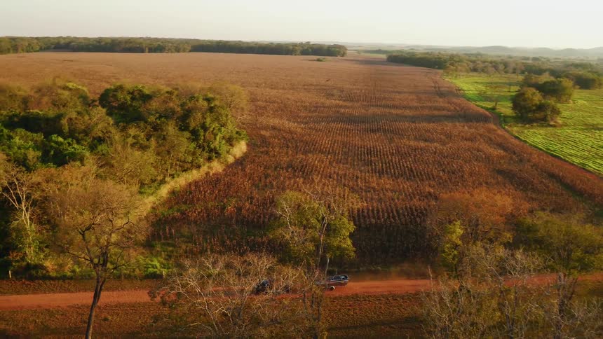 The truck pulls the boat past the farm