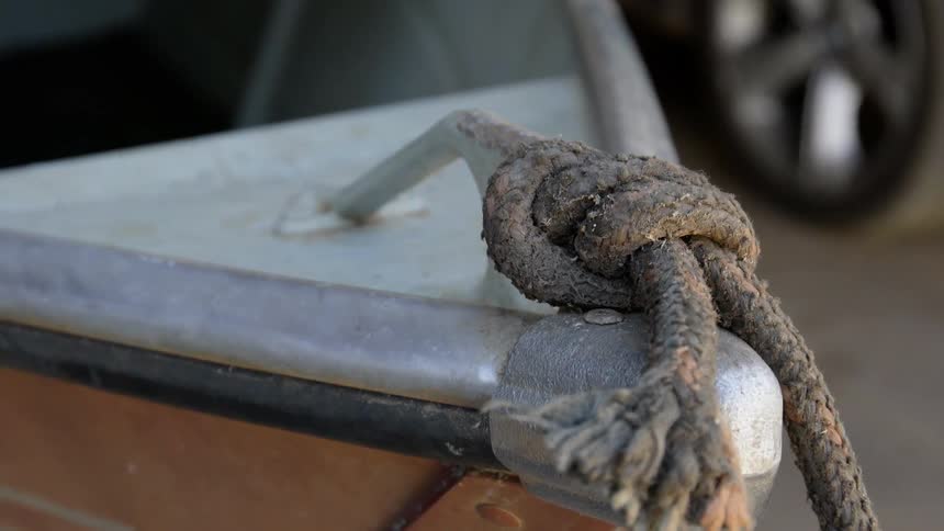 Rope hangs from the outside of a boat