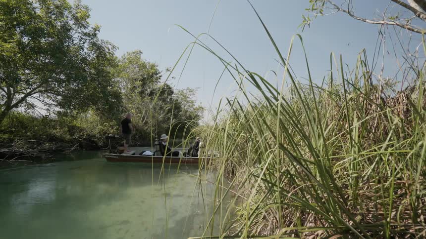 The small boat moves sideways in the stream