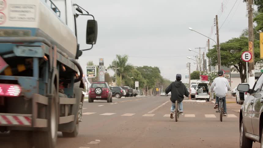 Boys ride bicycles on a city street