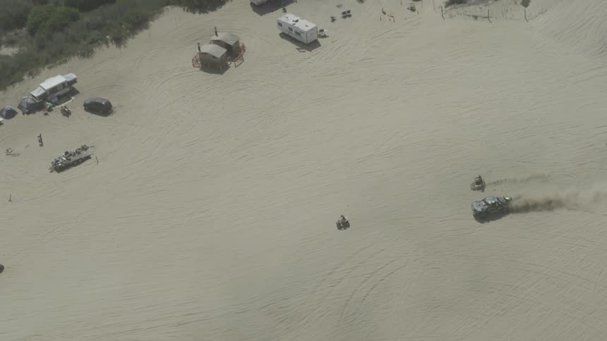 A car is driving through a desert