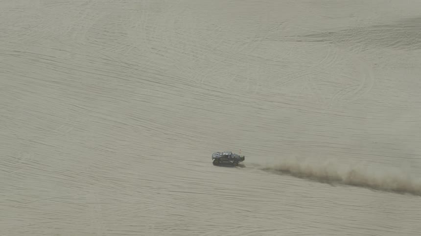 A car drives across a desert