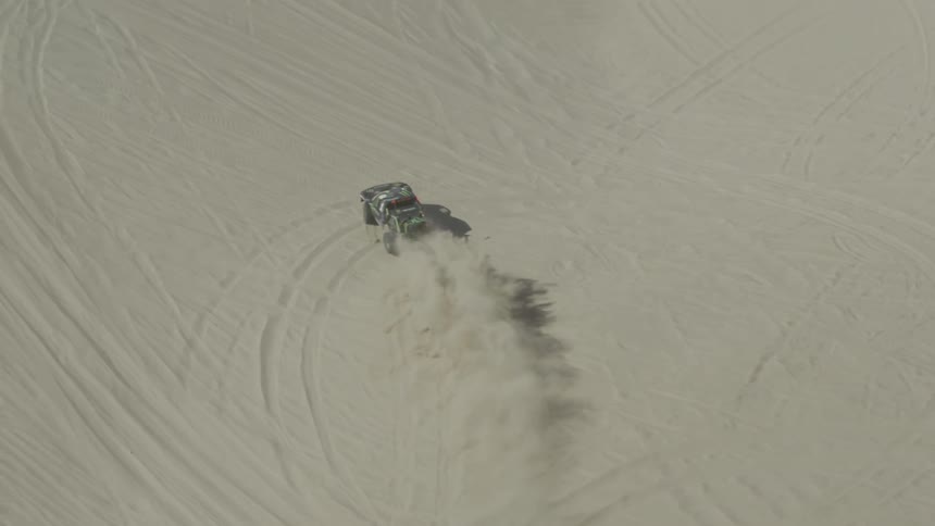 Vehicle driving fast in the sand
