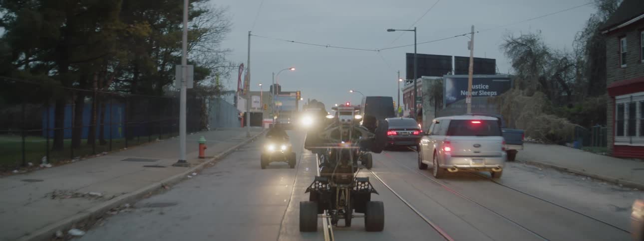 A group of men ride atvs on a city street