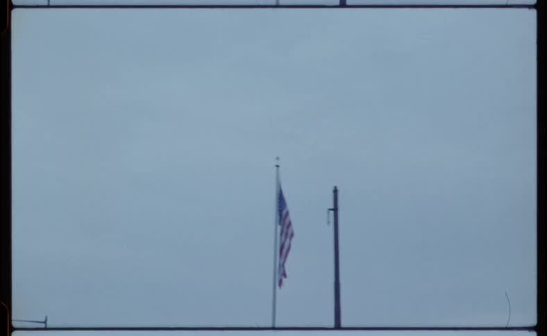American flag hangs limply from a flag pole