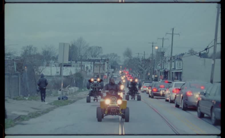 Four wheelers are driven on a city street