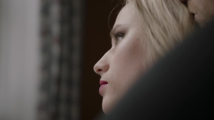 Woman looks out a window