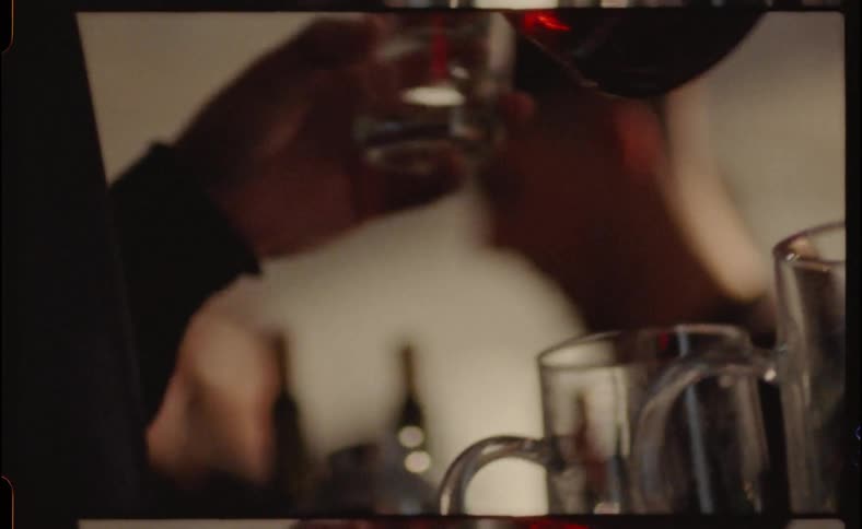 A man pours drinks at a bar