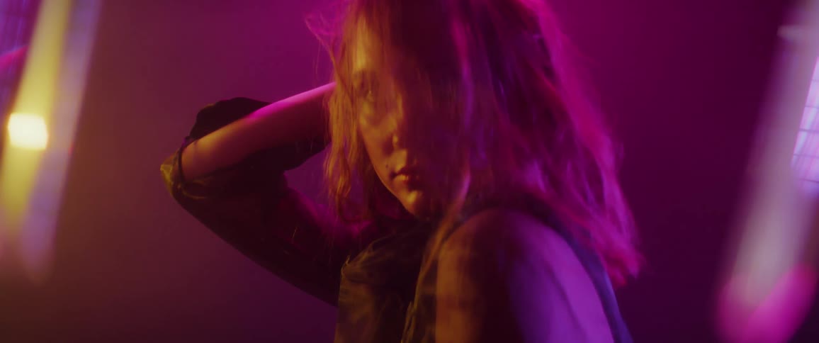 A woman touches her hair and poses