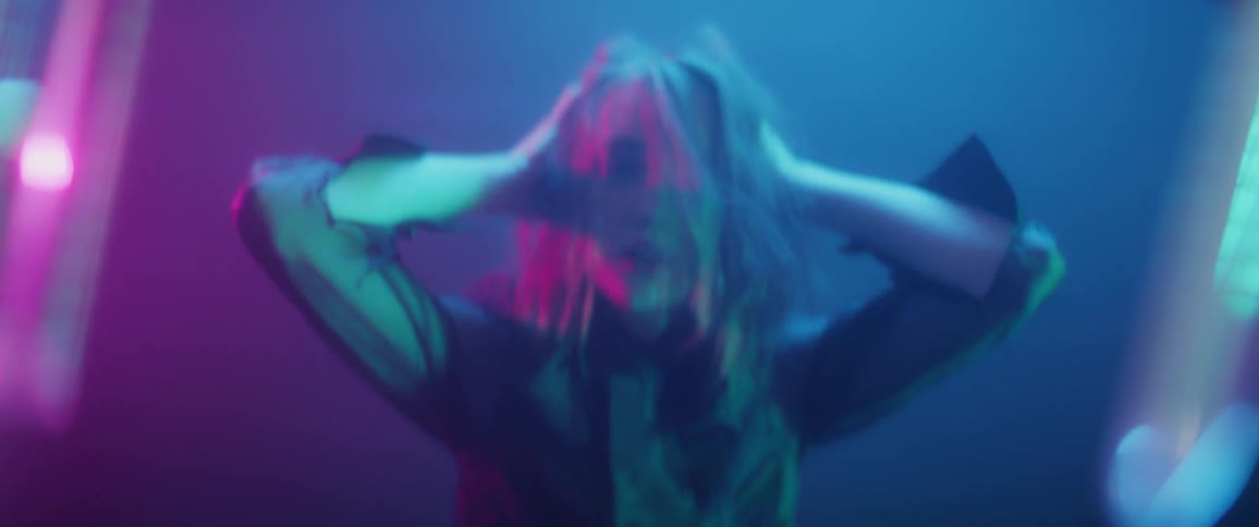 A woman messes her hair