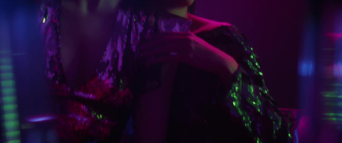 A woman is rubbing her thigh and leaning on another woman