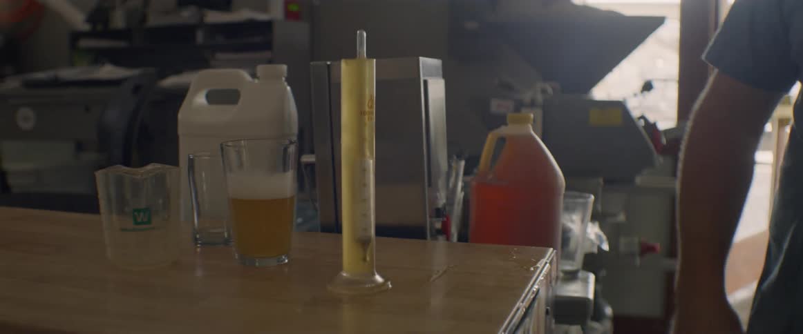 A man drops a thermometer into a tube of liquid