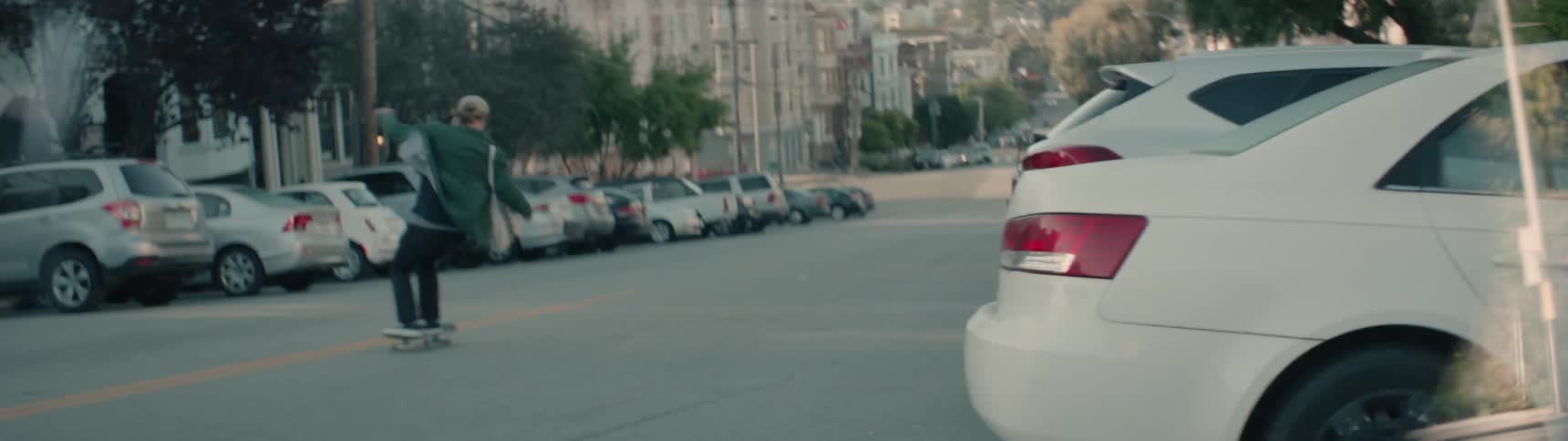 A person skateboards down the steep street