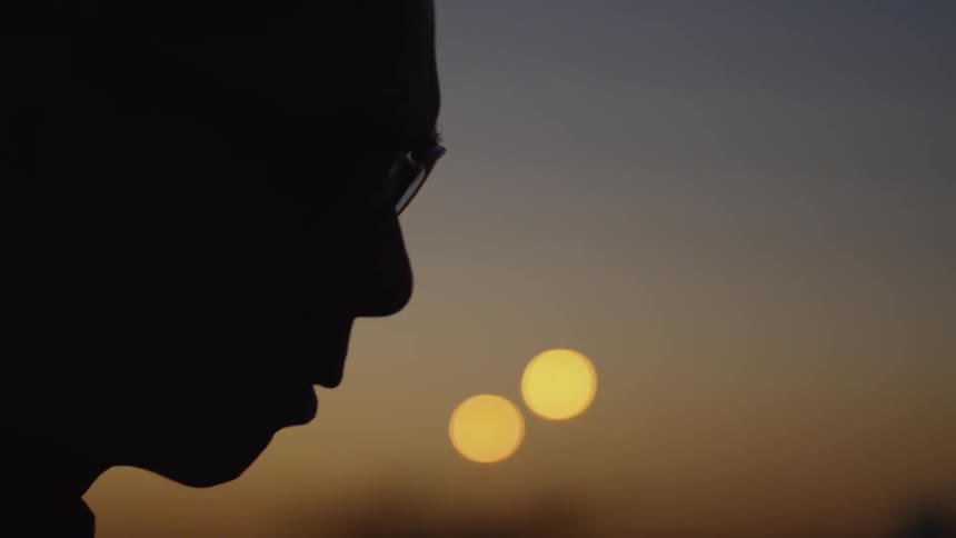 Man wears glasses as he stares intently