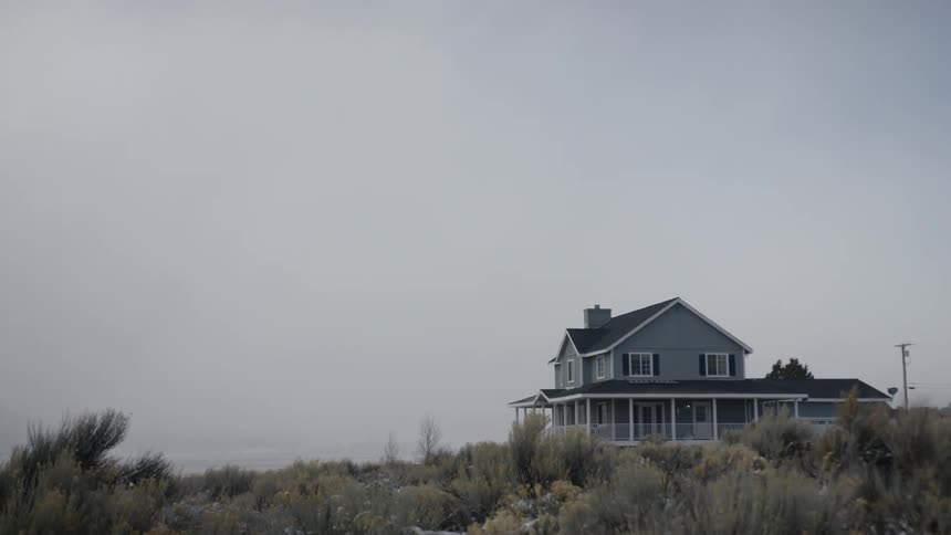 A house sits in a rural field