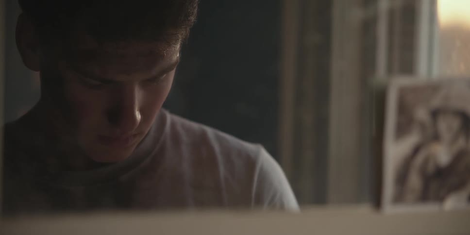 A young man looks through items on a shelf