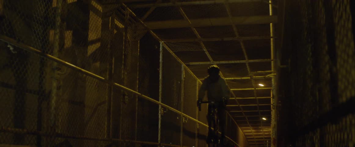Man rides a bike through a tunnel