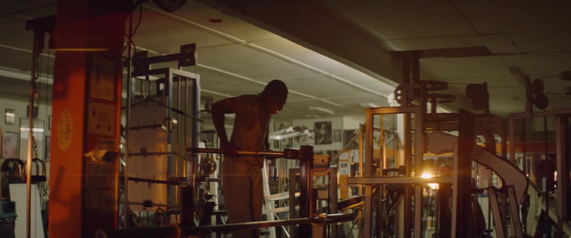 Man pushes himself up on bars in a gym