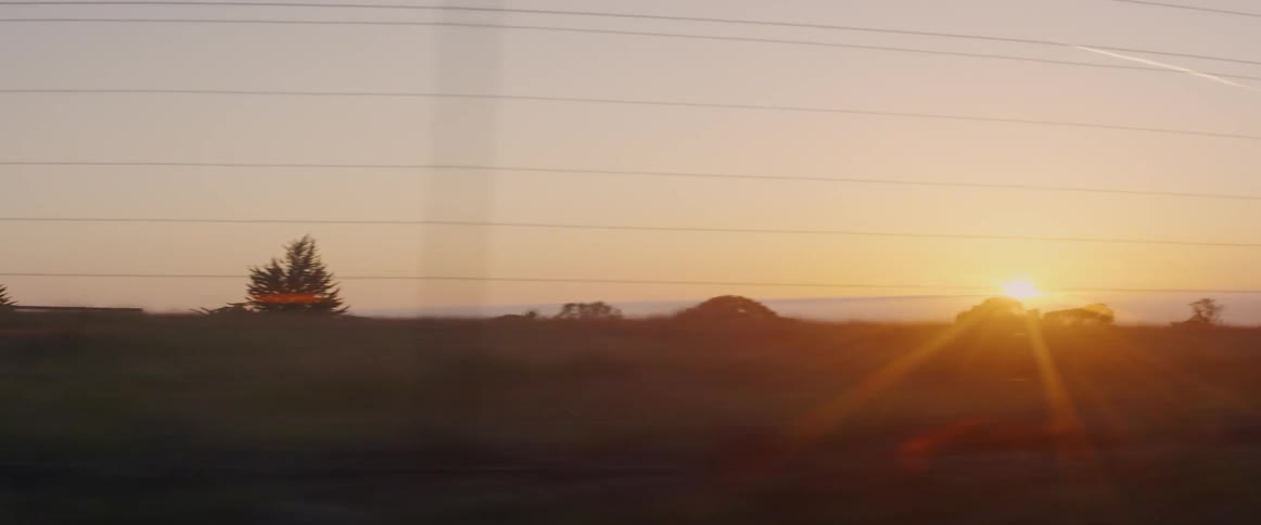 Farmland surrounded by fences at sunset