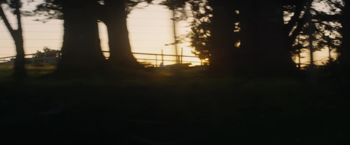 The sun i setting as the car drives by