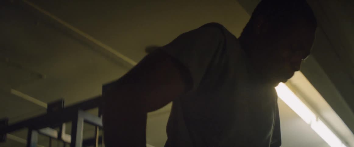 A man exercises in a weight room