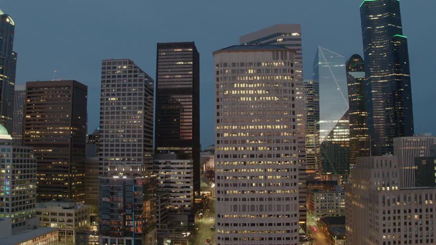 Orbiting around high rise buildings in downtown Seattle at dusk