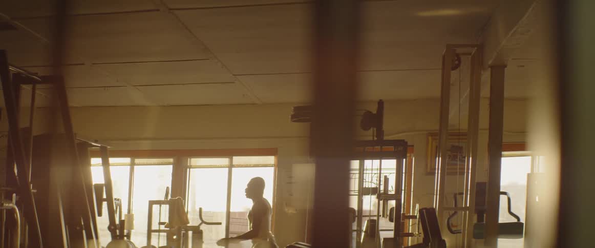 Man jumps rope surrounded by gym equipment