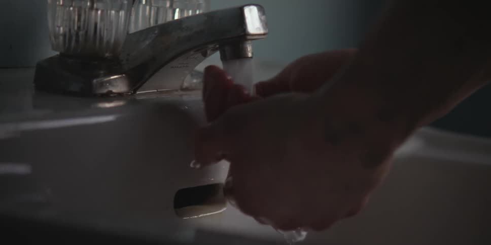 Person washing their hands in a sink