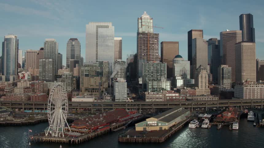 A ferris wheel spins along the Seattle waterfront