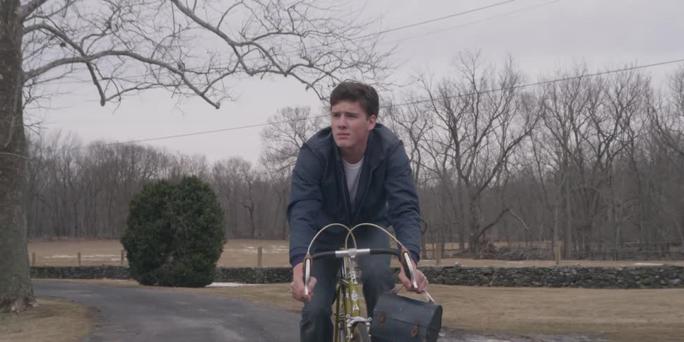 A man is biking through a town