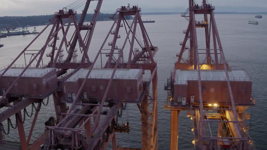 Orbiting around enormous maritime seaport cranes
