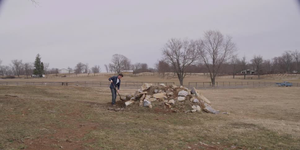 A person shoveling from a pile