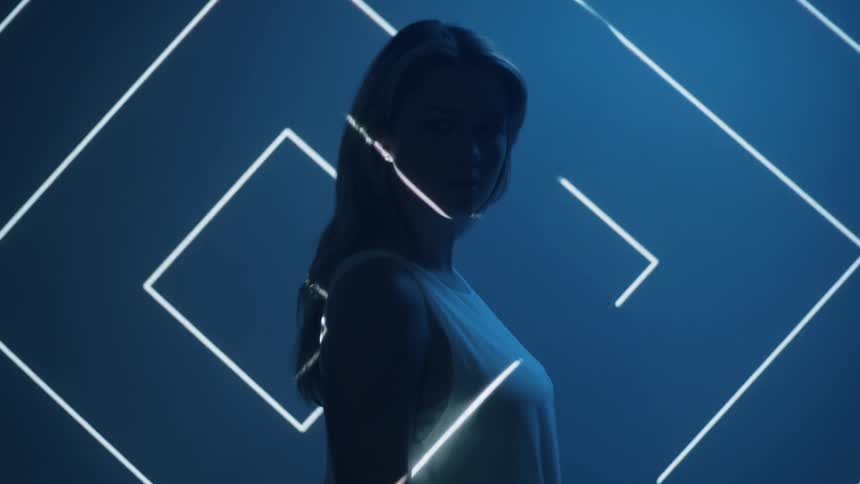 Woman stands in front of lights