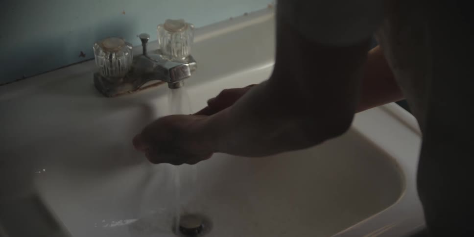 Person washing their hands in a sink
