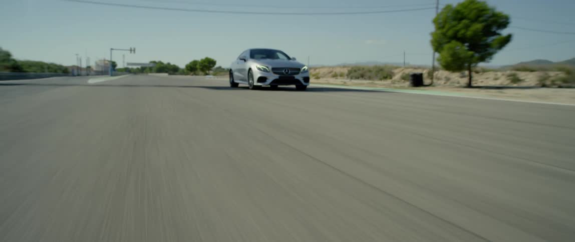A car drives on a rural road