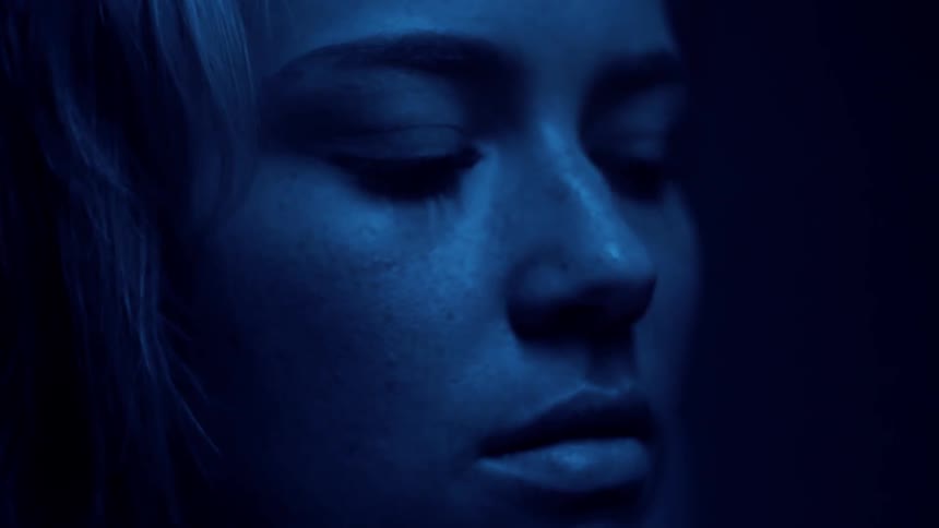 Woman's face illuminated by blue and red light