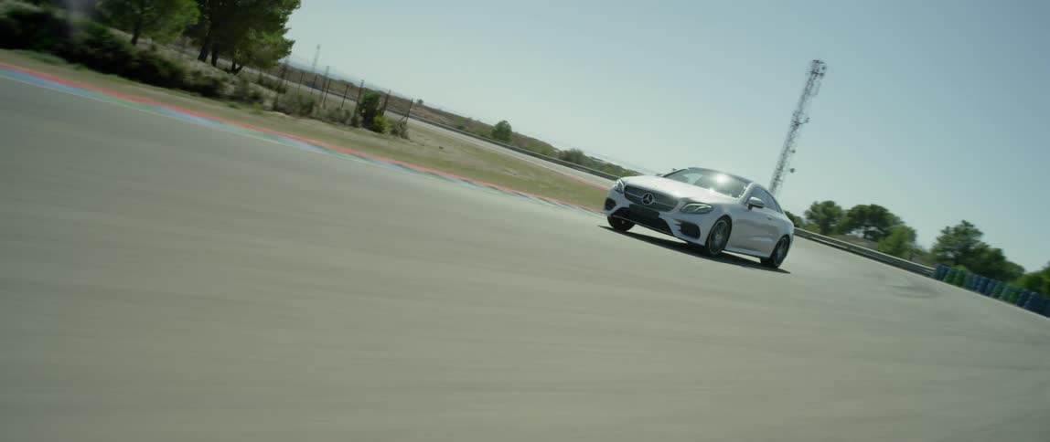 A car drives on a road on a sunny day