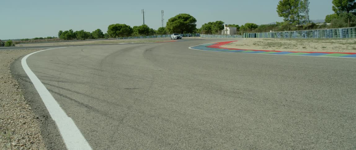 A car drives on a road on a sunny day