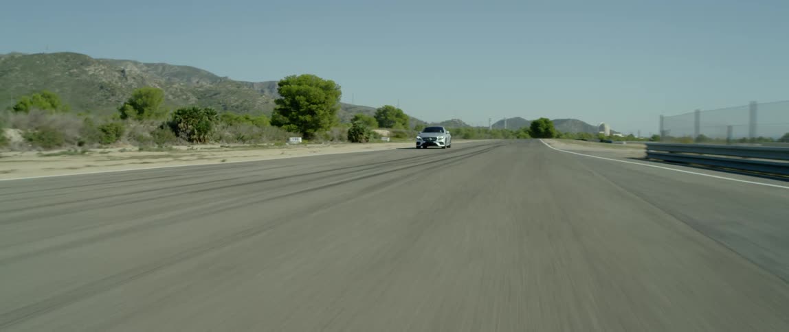 A car drives on a rural road